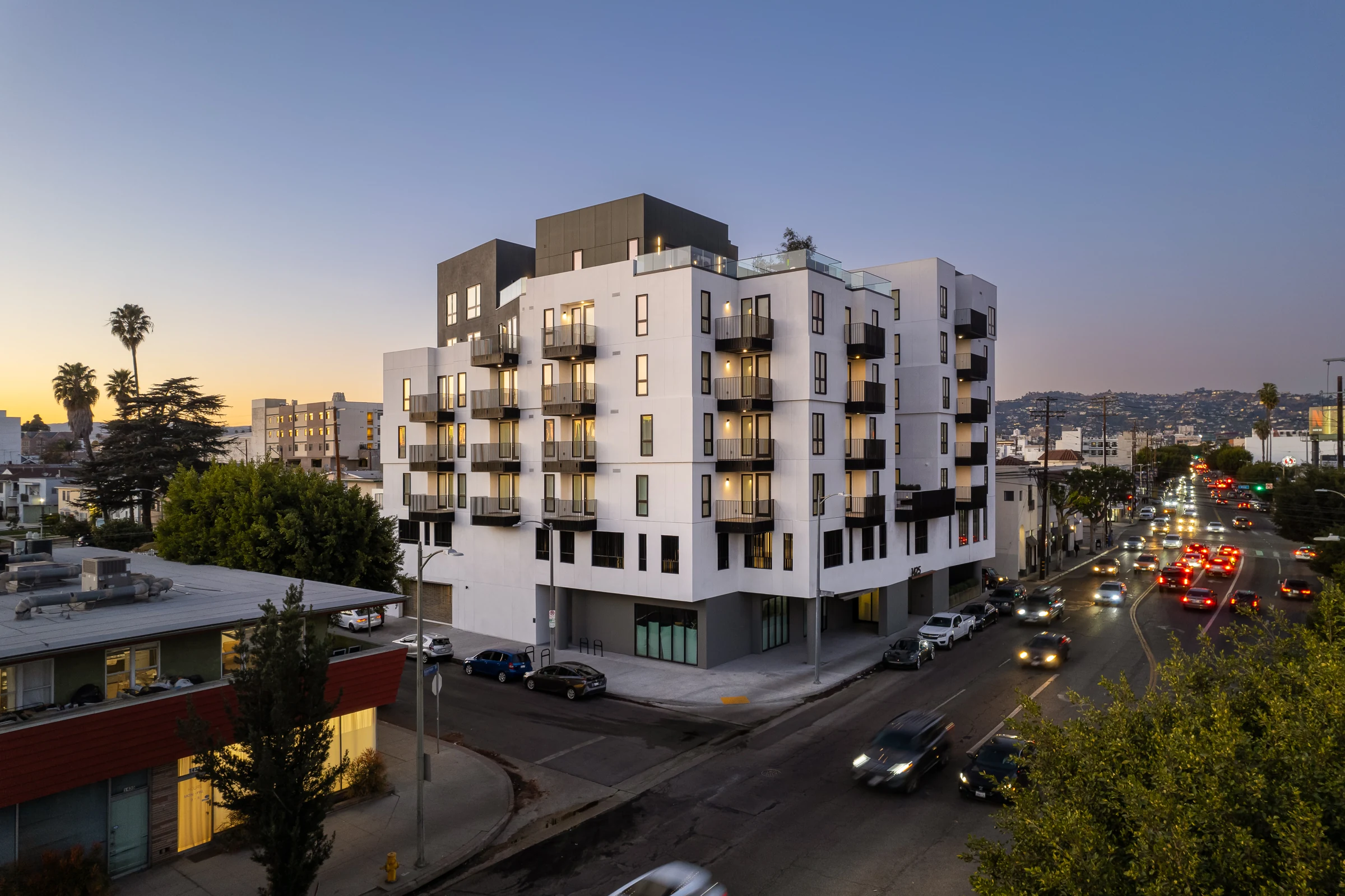 Aspekt, the 66-unit mixed-use building Jon Batmanghelich developed on Robertson Boulevard in Los Angeles, photographed at dusk.